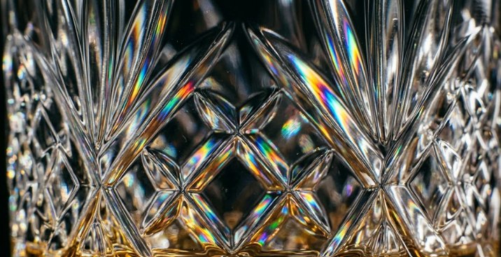 Close-up of a cut-crystal whisky tumbler, each facet sparkling in the light