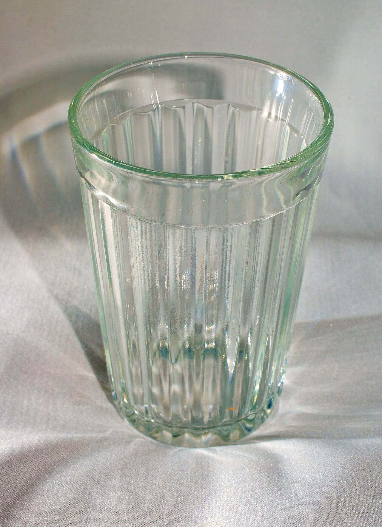 A thick Soviet glass with vertical cut facets and a smooth band around the top