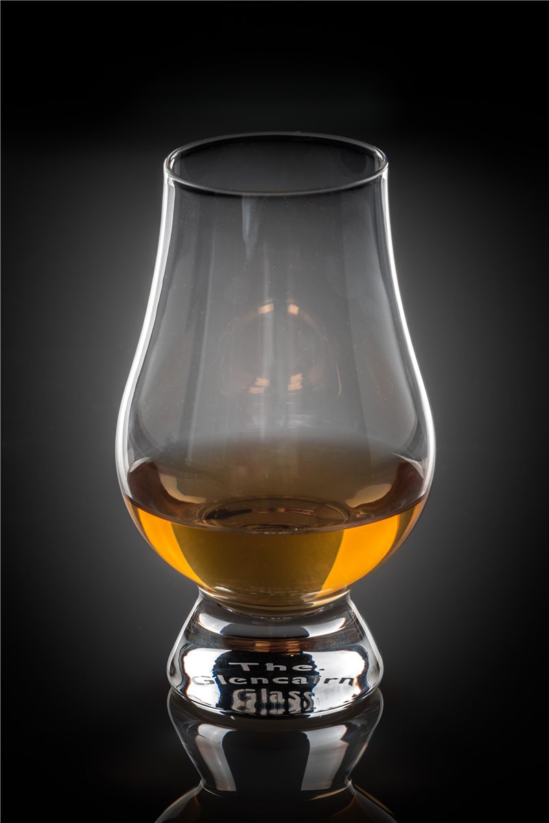 Amber whisky in a Glencairn nosing glass